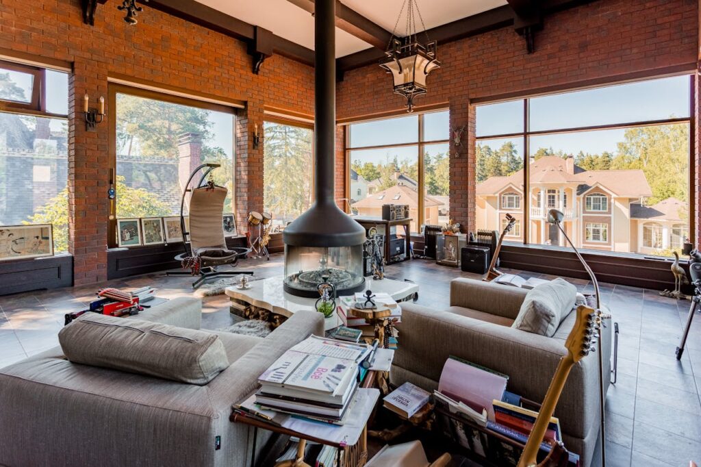 A living room with a fireplace and a large window