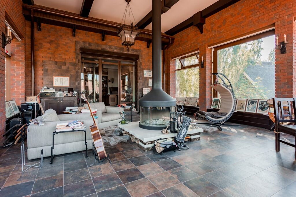 A living room with a fireplace and a large window